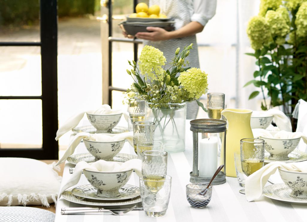 wiosenna dekoracja stołu w szaro-żółtym kolorze,skandynawska ceramika szaro-biała,szaro-białe kubki i talerze,zastawa stołowa w monych szarych kolorach,jasnożółte dzbanki i miski